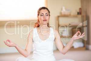 Woman in yoga pose while meditating