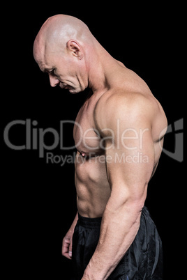 Side view of sad muscular man looking down