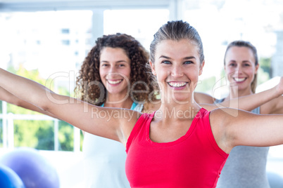 Portrait of cheerful women with arms outstretched