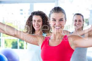Portrait of cheerful women with arms outstretched