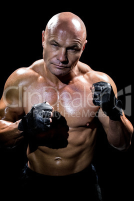 Portrait of muscular man with fighting stance