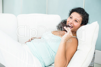 Pregnant woman eating chocolate bar
