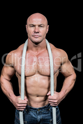 Portrait of healthy man holding rope