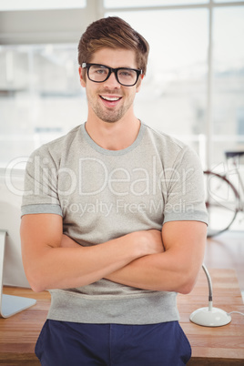 Hipster wearing eye glasses leaning at desk