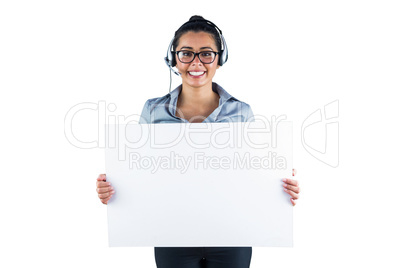 Smiling businesswoman wearing headset and holding white sheet