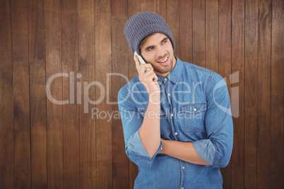 Hipster wearing klnitted hat using mobile phone