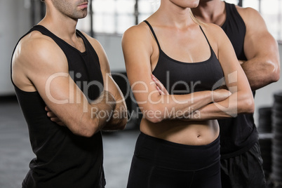 Midsection of people with arms crossed