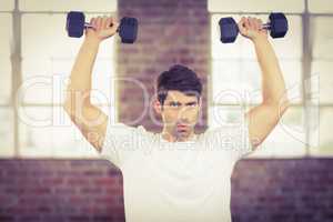 Portrait of muscular man lifting dumbbells