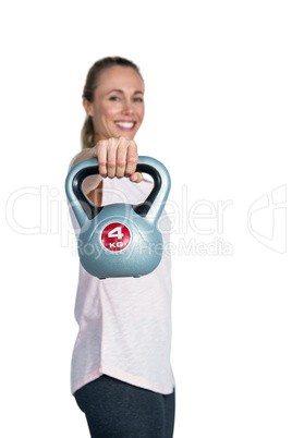 Cheerful sporty woman exercising with kettlebell