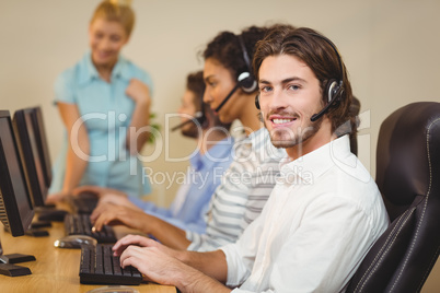 Smiling male employee with coworkers