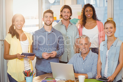 Smiling business people with technologies in meeting room