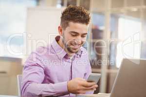 Businessman using smart phone  in office