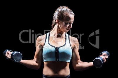 Sporty woman lifting dumbbells