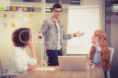 Businessman explaining female colleagues