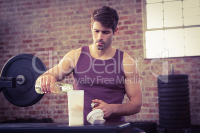 Man pouring water into shaker bottle