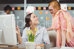 Happy businesswomen using computer in office