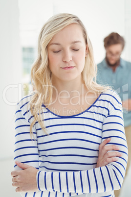 Woman with eyes closed and arms crossed