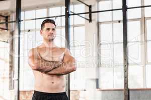Portrait of shirtless muscular man with arms crossed