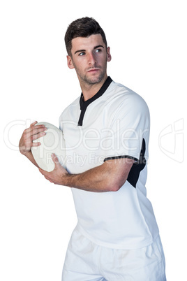 Rugby player posing while holding the ball