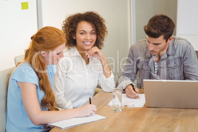 Smiling businesswoman with colleagues in meeting