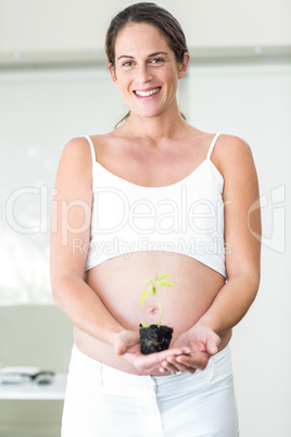 Portrait of woman holding new plant