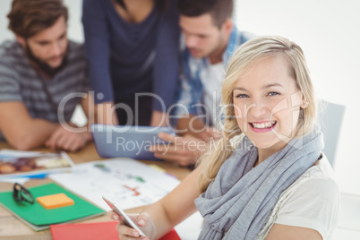 Portrait of cheerful woman using smartphone