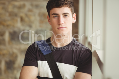 Portrait of confident male leaning on window