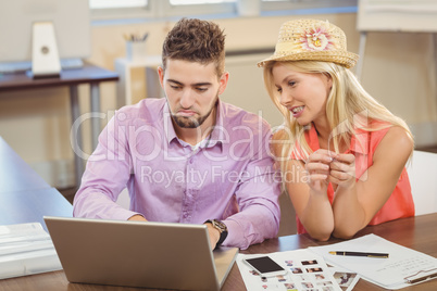 Business woman sitting by male colleague