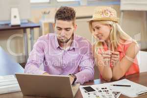 Business woman sitting by male colleague