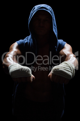Athlete in hood with bandage on hand