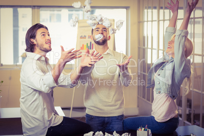 Business people having fun with paper balls