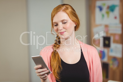 Businesswoman texting on phone