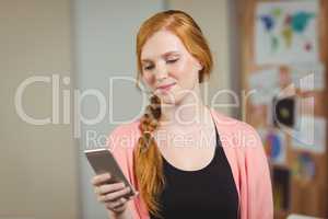 Businesswoman texting on phone