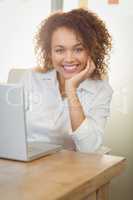 Smiling businesswoman with hand on chin