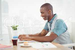 Smiling man working on laptop