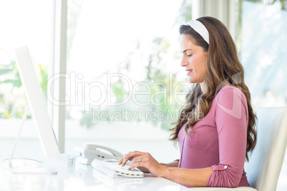 Side view of businesswoman typing on keyboard