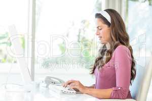 Side view of businesswoman typing on keyboard