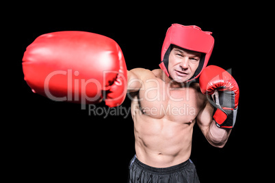 Boxer punching against black background