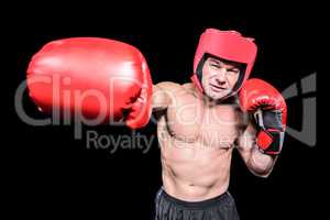 Boxer punching against black background