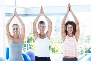 Smiling women with joined hands overhead