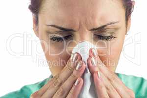 Woman suffering from cold with tissue on mouth