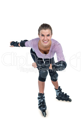 Portrait of happy young woman inline skating