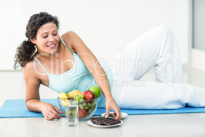 Pregnant woman about to hold chocolate bar