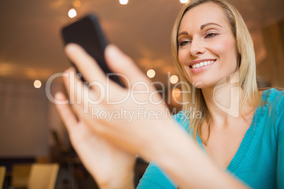 Happy young woman using mobile phone