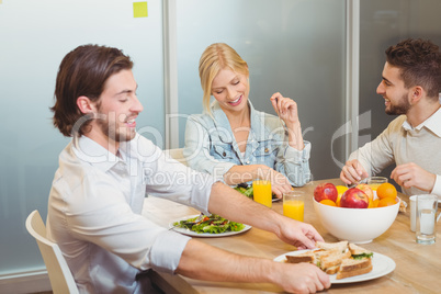 Businessman holding plate of sandwich