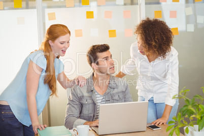 Businesswomen discussing with male colleague