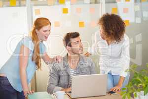 Businesswomen discussing with male colleague