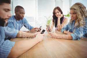 Business people using technology at desk