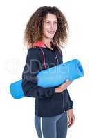 Happy young woman holding exercise mat