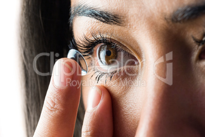 Woman about to insert her contact lens